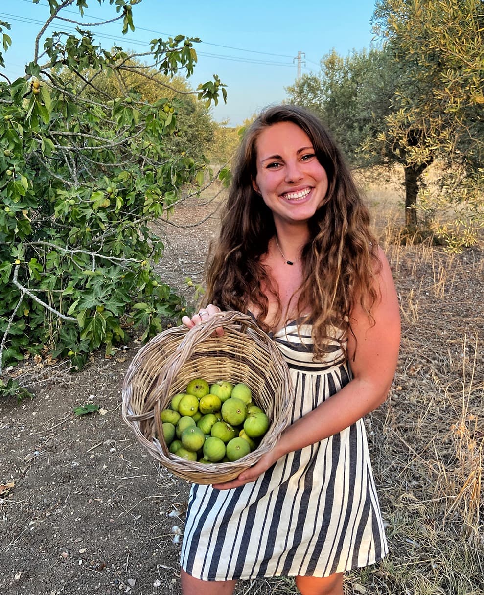 Tiia holding a basket of freshly picked figs
